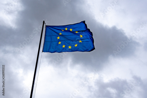 Flag of European Union, EU, on dramatic cloudy sky on background