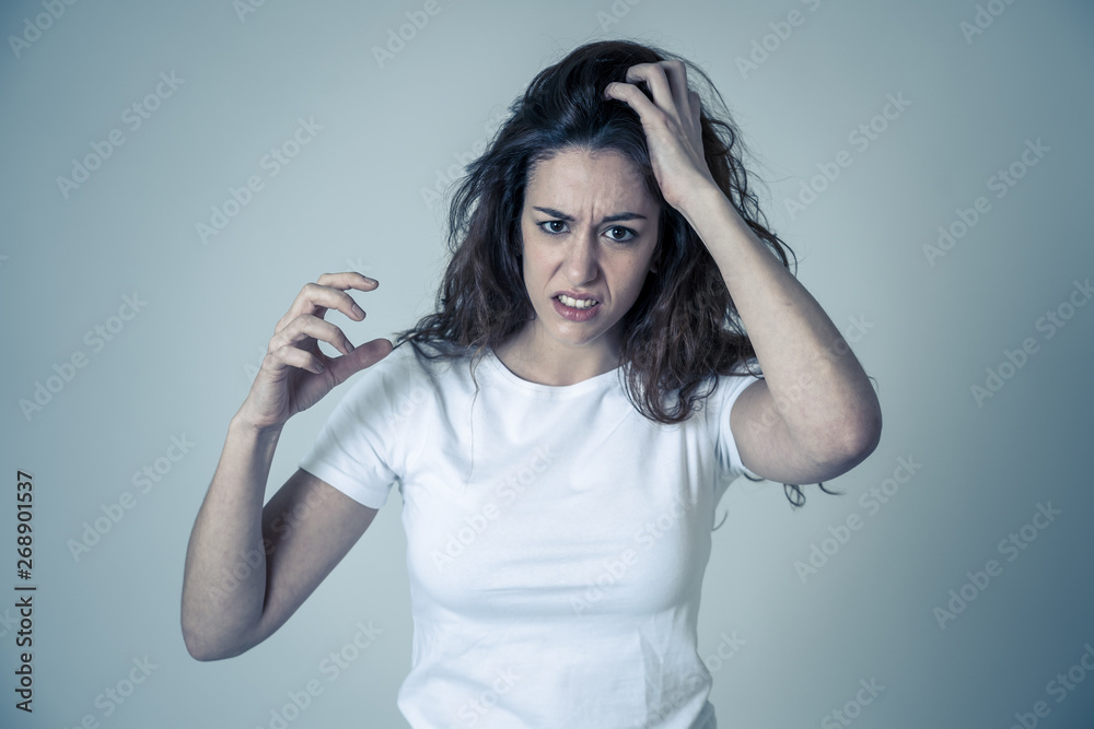 Red haired beautiful young woman with angry face looking furious. Human expressions and emotions Red haired beautiful young woman with angry face looking furious. Human expressions and emotions