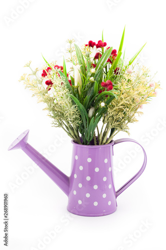 Plastic flower decorate in watering can isolated on white background