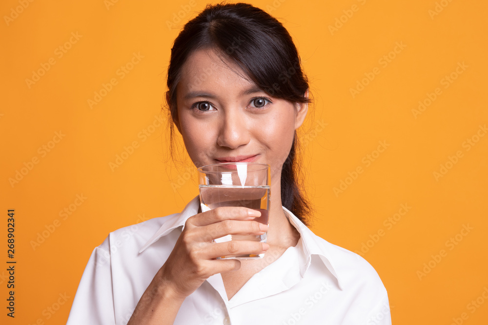 Young Asian woman with a glass of drinking water. Young Asian woman with a glass of drinking water.