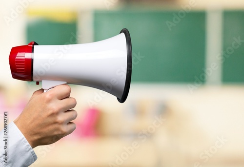 Close-up Human Hand with Megaphone on background