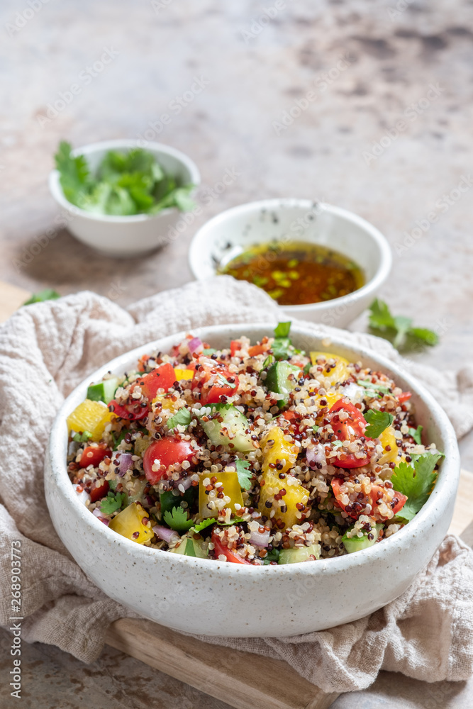Fresh quinoa tabbouleh salad with tomatoes, peppers and cucumbers Fresh quinoa tabbouleh salad with tomatoes, peppers and cucumbers