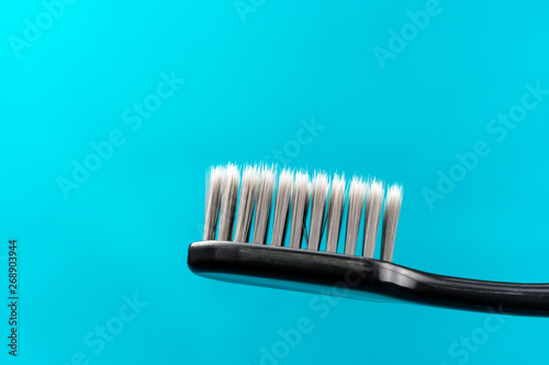 Charcoal Toothbrush on a green background