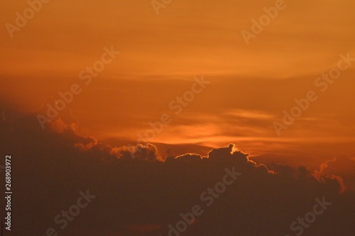 Silhouette sunset with orange sky with clouds at dusk