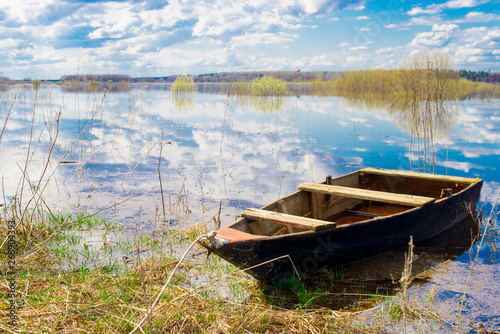 Old wooden boat near the river. Spring flood © Павел Страхов