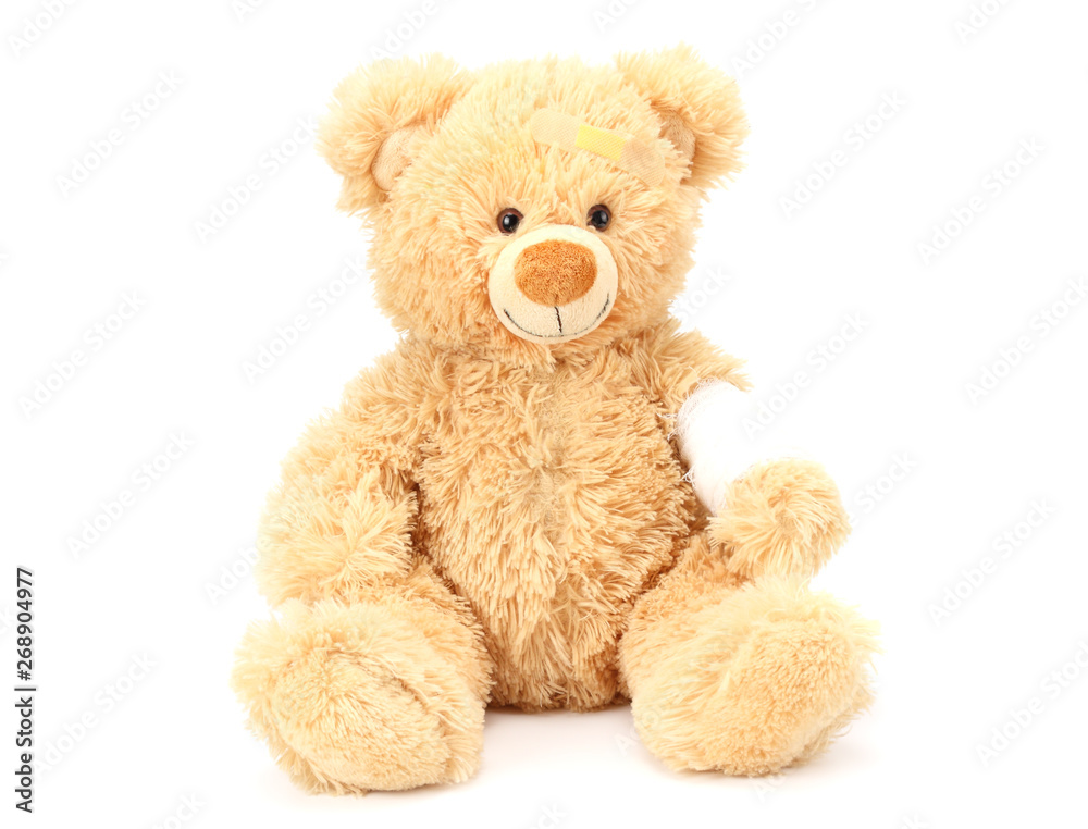 toy teddy bear with bandage isolated on white background