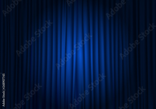 Spotlight on stage curtain. Closed blue curtain background. Theatrical drapes. photo