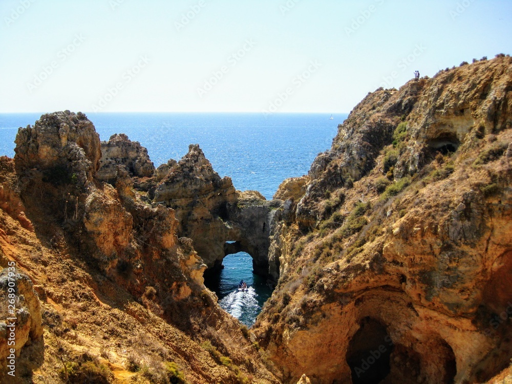 Algarve coast with rocky formations. Atlantic coast landscape in Algarve region. Seashore and caves near Lagos, Portugal, Europe