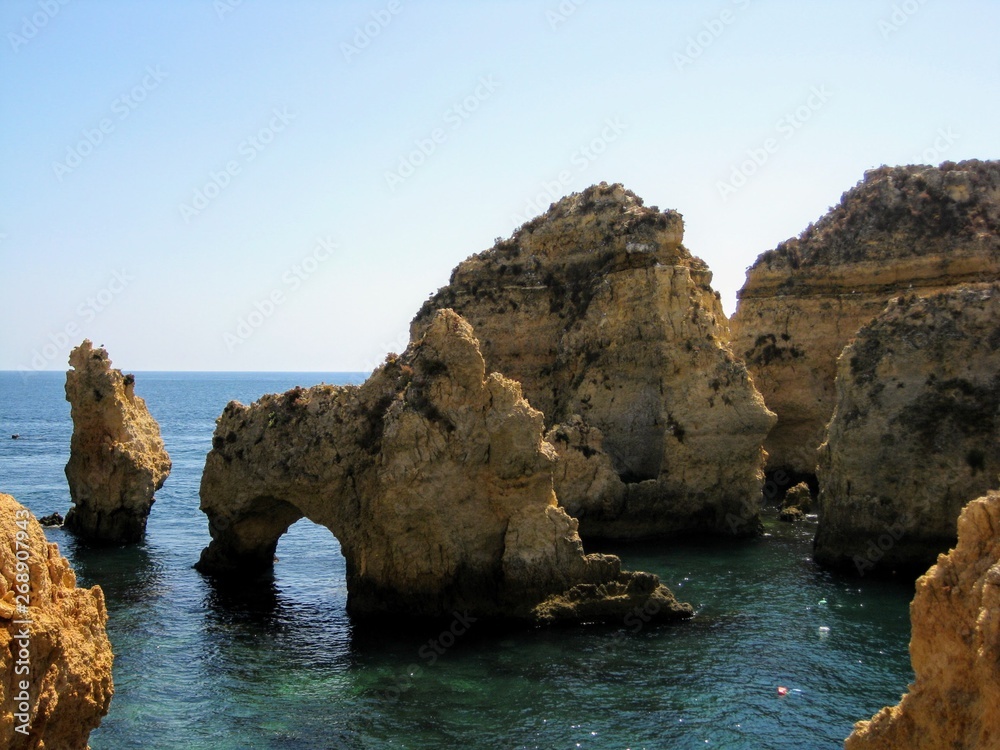 Algarve coast with rocky formations. Atlantic coast landscape in Algarve region. Seashore and caves near Lagos, Portugal, Europe