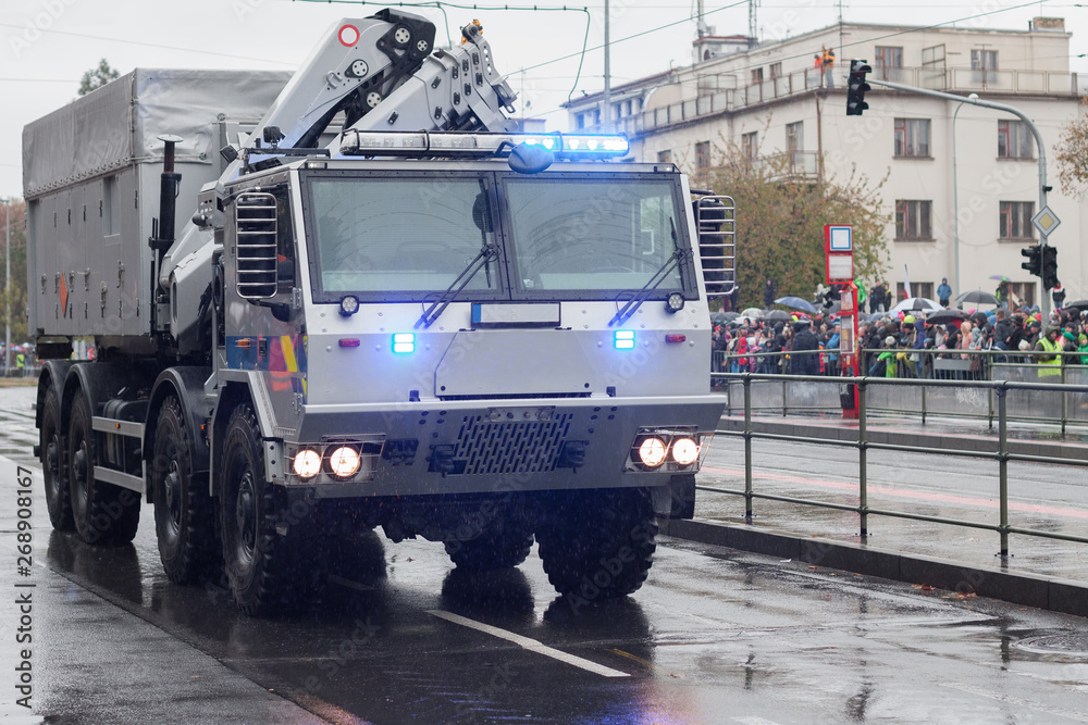  Police workers are riding police truck on military parade