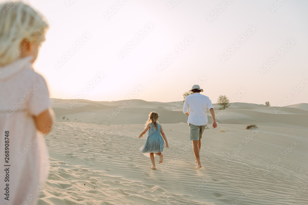 father with a daughter in the desert in Dubai
