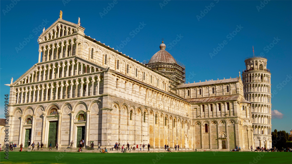 Tourists at Pisa Cathedral and Leaning Tower of Pisa in Italy