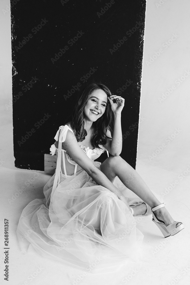 Obraz premium attractive fashionable woman posing in pink dress on a white background in the studio