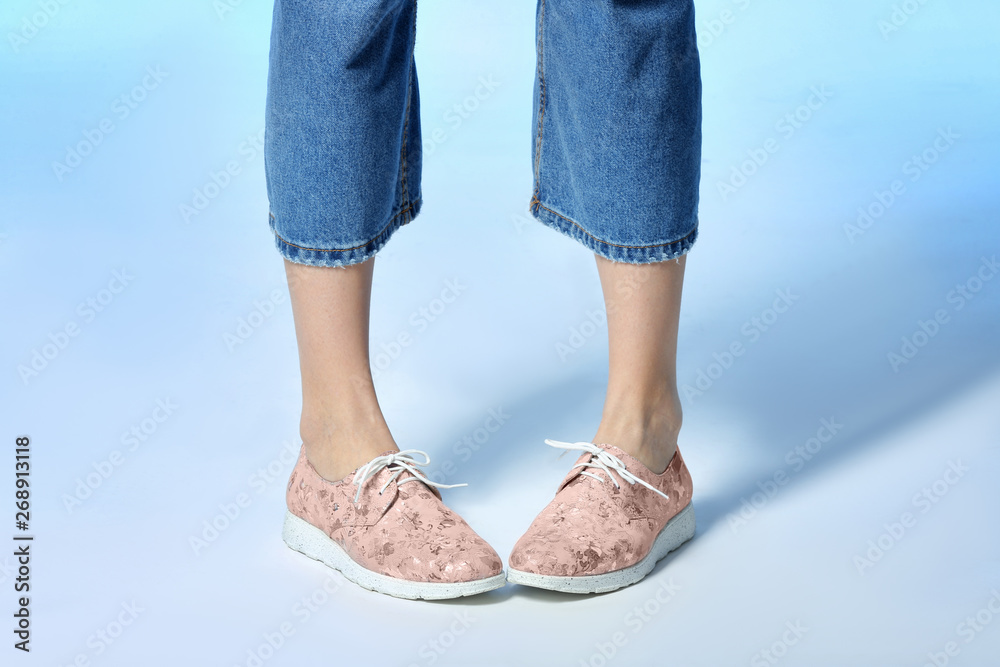 Woman in stylish shoes on color background, closeup Woman in stylish shoes on color background, closeup