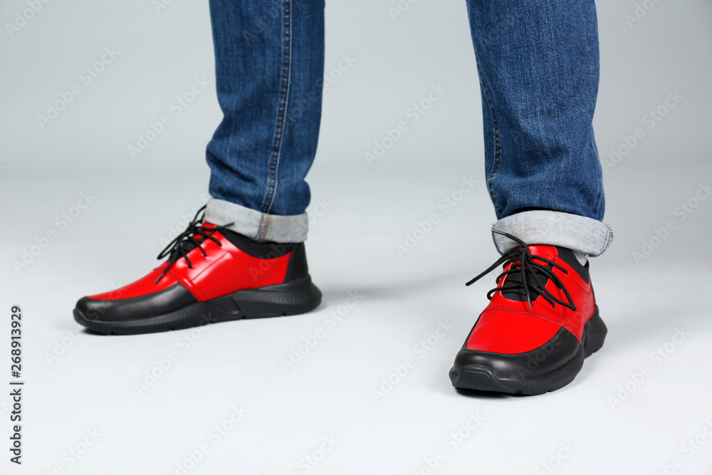 Man in stylish sport shoes on light background Man in stylish sport shoes on light background