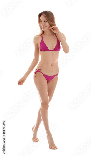 Young slim woman in bikini on white background. Perfect body