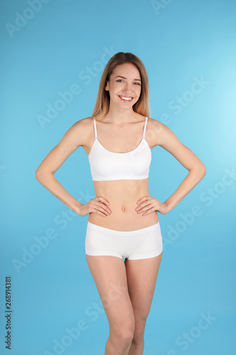 Young slim woman on color background. Perfect body