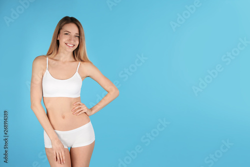 Young slim woman on color background, space for text. Perfect body