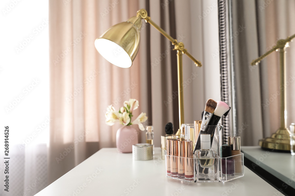 Luxury makeup products and accessories on dressing table with mirror. Space for text - obrazy, fototapety, plakaty 