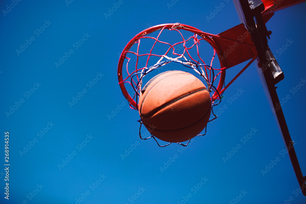 Basketball ball on hoop,pointing concept Basketball ball on hoop,pointing concept