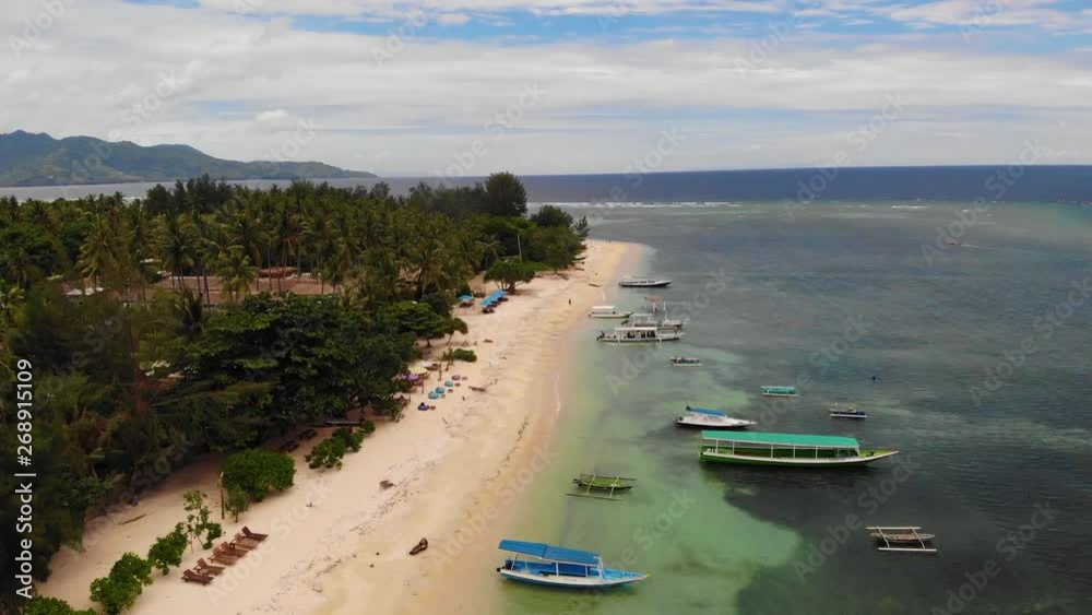 Aerial - drone flying over peaceful tropical bay and boats. Bali, Indonesia. Aerial - drone flying over peaceful tropical bay and boats. Bali, Indonesia.