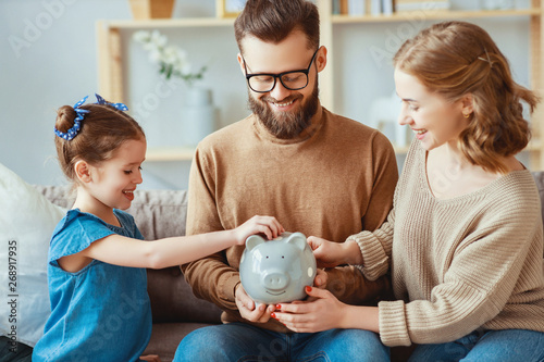 family savings, budget planning, children's pocket money. family with piggy Bank  . photo