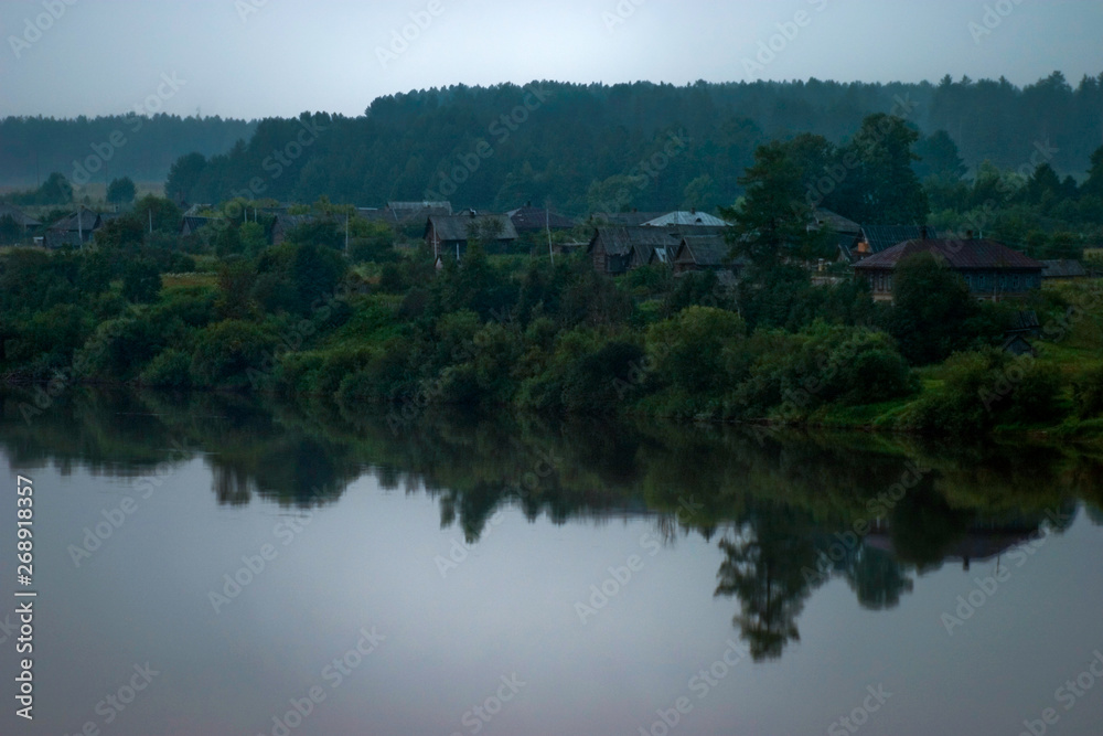 Silence early in the morning in the village on the river
