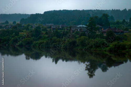 Silence early in the morning in the village on the river