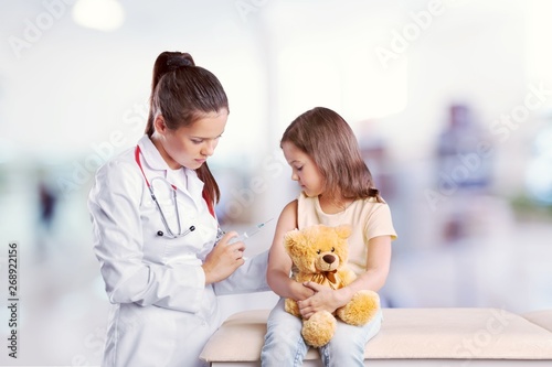 Young woman doctor with little girl