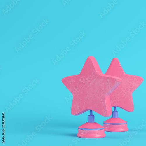 Stars with stand on bright blue background in pastel colors. Minimalism concept