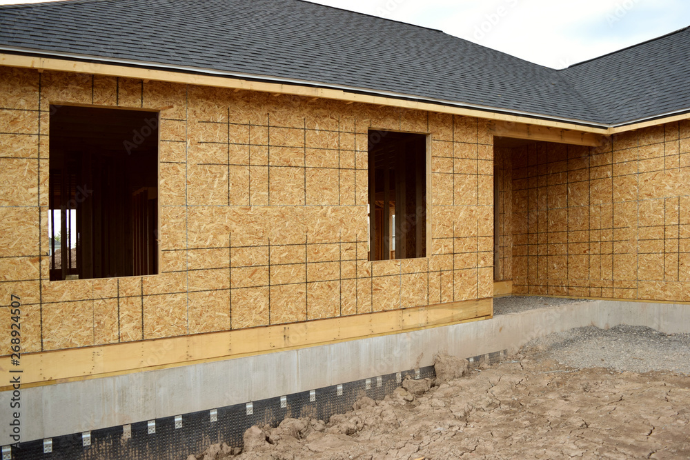 New Home Under Construction with Lumber Framing and Carpentry Builders Craftsman