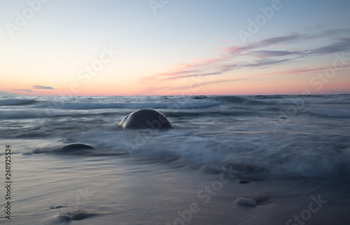 Beautiful ocean sunset with rocks and waves