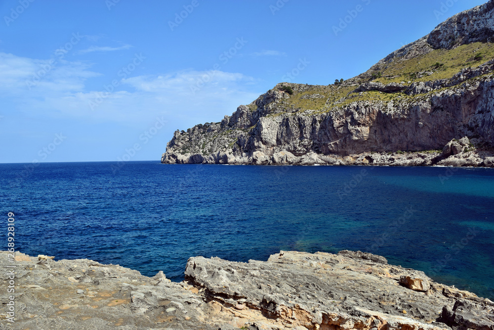 Fototapeta premium Sea bay with turquoise water, beach and mountains, Cala Figuera on Cap Formentor