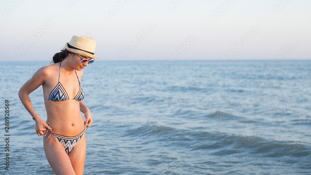 beautiful woman swim wear at the beach in sunny summer