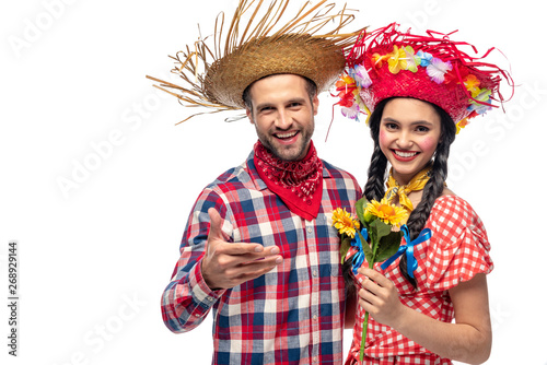 cheerful man and young woman in festive clothes with sunflowers isolated on white