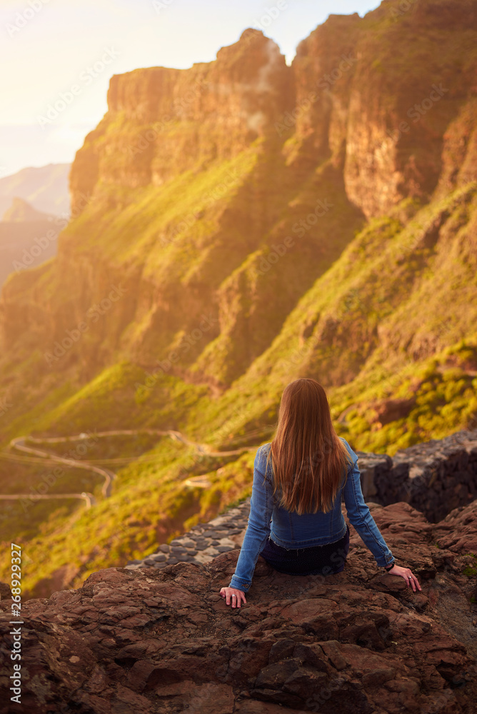 Young woman contemplating the road to Masca in Tenerife, Canary Islands, Spain