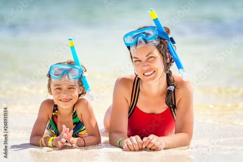 Young mother and little daughter in snorkeling masks enjoing the beach in Dominican Republic