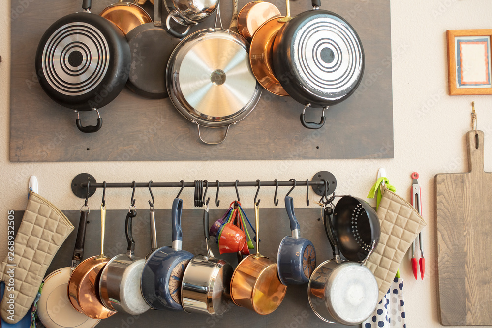 Kitchen wall rack for hanging pots, pans, aprons, and other utensils