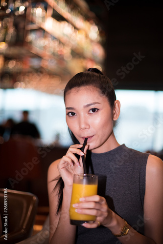 Working Asian Woman Black hair having Lunch Dinner of vegetable fruit Juice glass Western food in fusion restaurant cafe and eat alone. Concept enjoy eating myself for good food life