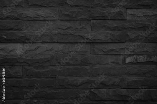 Wall dark black brick texture background.