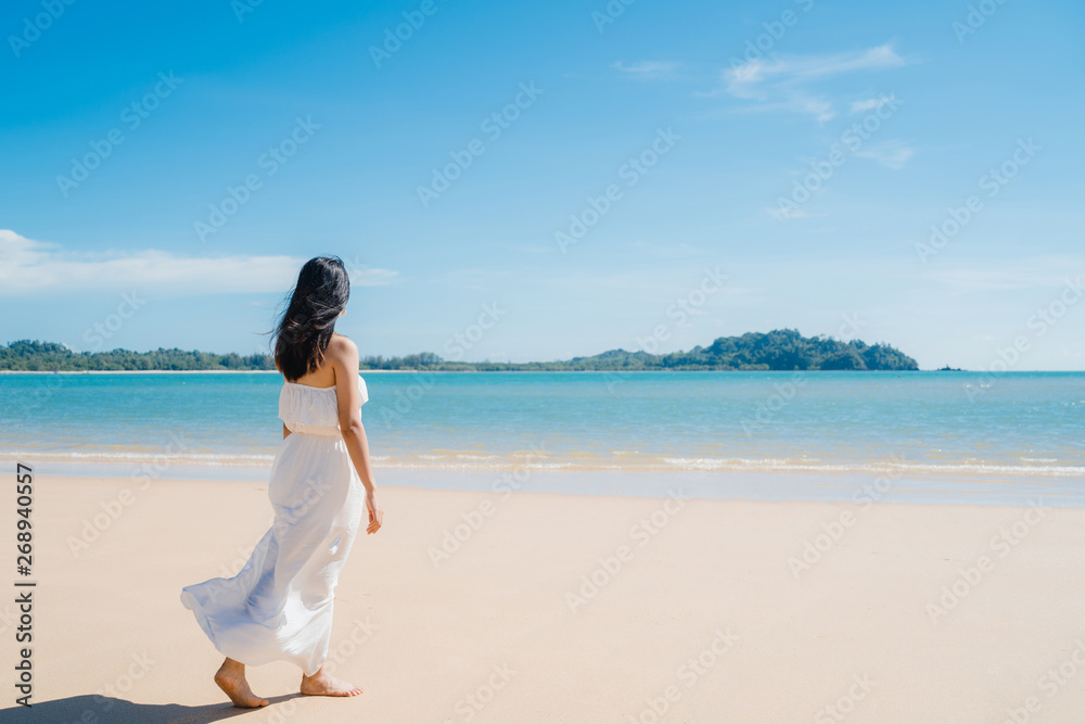 Beautiful young Asian woman happy relax walking on beach near sea. Lifestyle women travel on beach concept. Beautiful young Asian woman happy relax walking on beach near sea. Lifestyle women travel on beach concept.