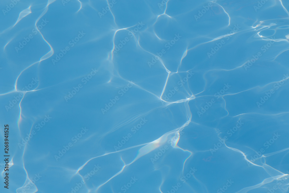 Obraz premium Blue pool water with sun reflections