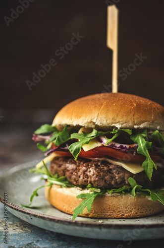  Tasty beef burger with vegetables on the table