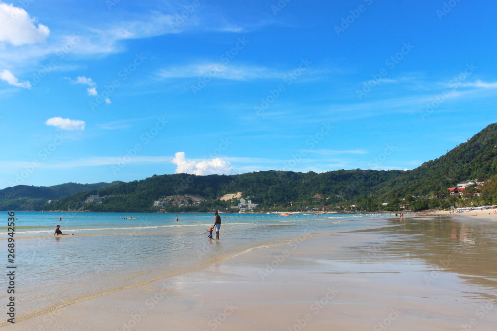 Phuket Province, Thailand - November17, 2017: Nai Harn Beach. Beautiful beach and sea in Phuket, Thailand.   Traveller from around the world come to relax in the summer holidays.