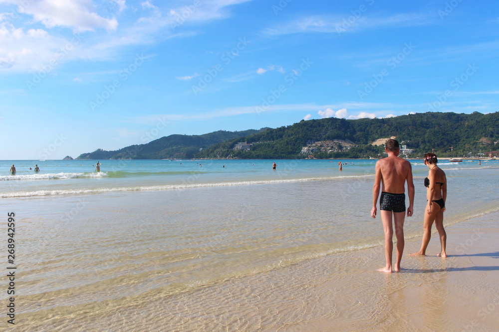 Phuket Province, Thailand - November17, 2017: Nai Harn Beach. Beautiful beach and sea in Phuket, Thailand.   Traveller from around the world come to relax in the summer holidays.