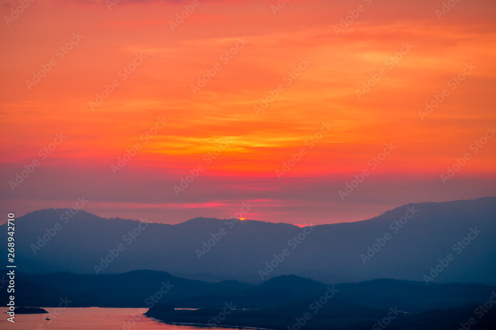 Fototapeta premium The natural background of the beautiful twilight sky, the surrounding atmosphere (trees, rivers, mountains) is a beautiful view of the journey, the view point. 