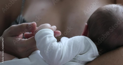 Baby little hand holding mother finger, first day of life