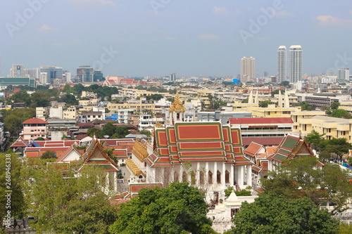 Bangkok Province, Thailand - February 3, 2019: Aerial view of Bangkok modern office buildings and temple. Take a picture from Wat Sraket Rajavaravihara (Golden Mount). photo