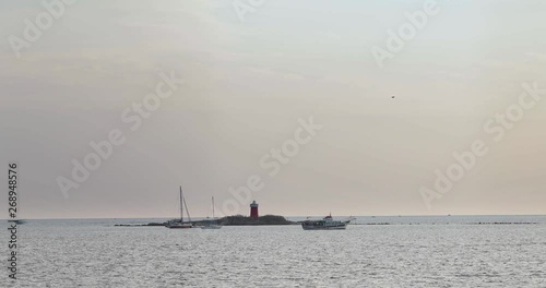 A sea view with speed boats and ships in Alghero in Sardinia island after sunset. photo