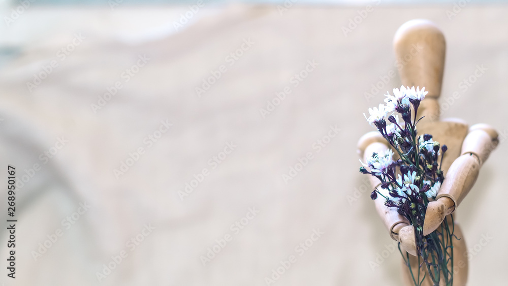 wooden man holding before him a bouquet of flower .Valentine's day, international women's day, mother's day wooden man holding before him a bouquet of flower .Valentine's day, international women's day, mother's day